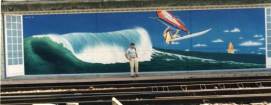 fresque murale d'une planche � voile surfant sur une grande vague le long des voies sncf